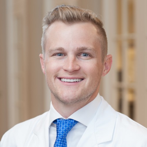 Michael Higgins, MD, in a white coat